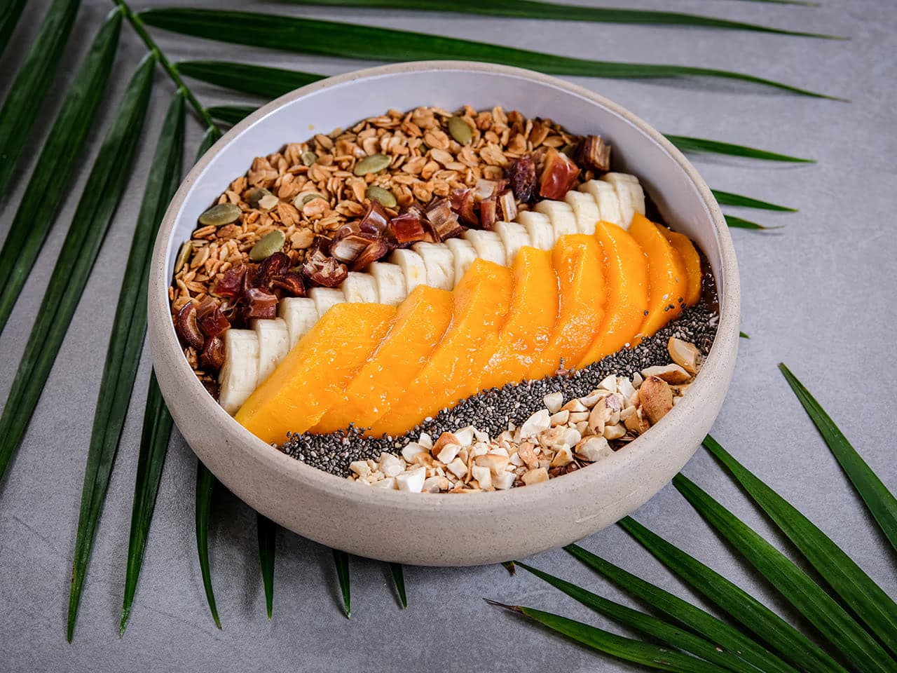Smoothie bowl with mango, banana and granola