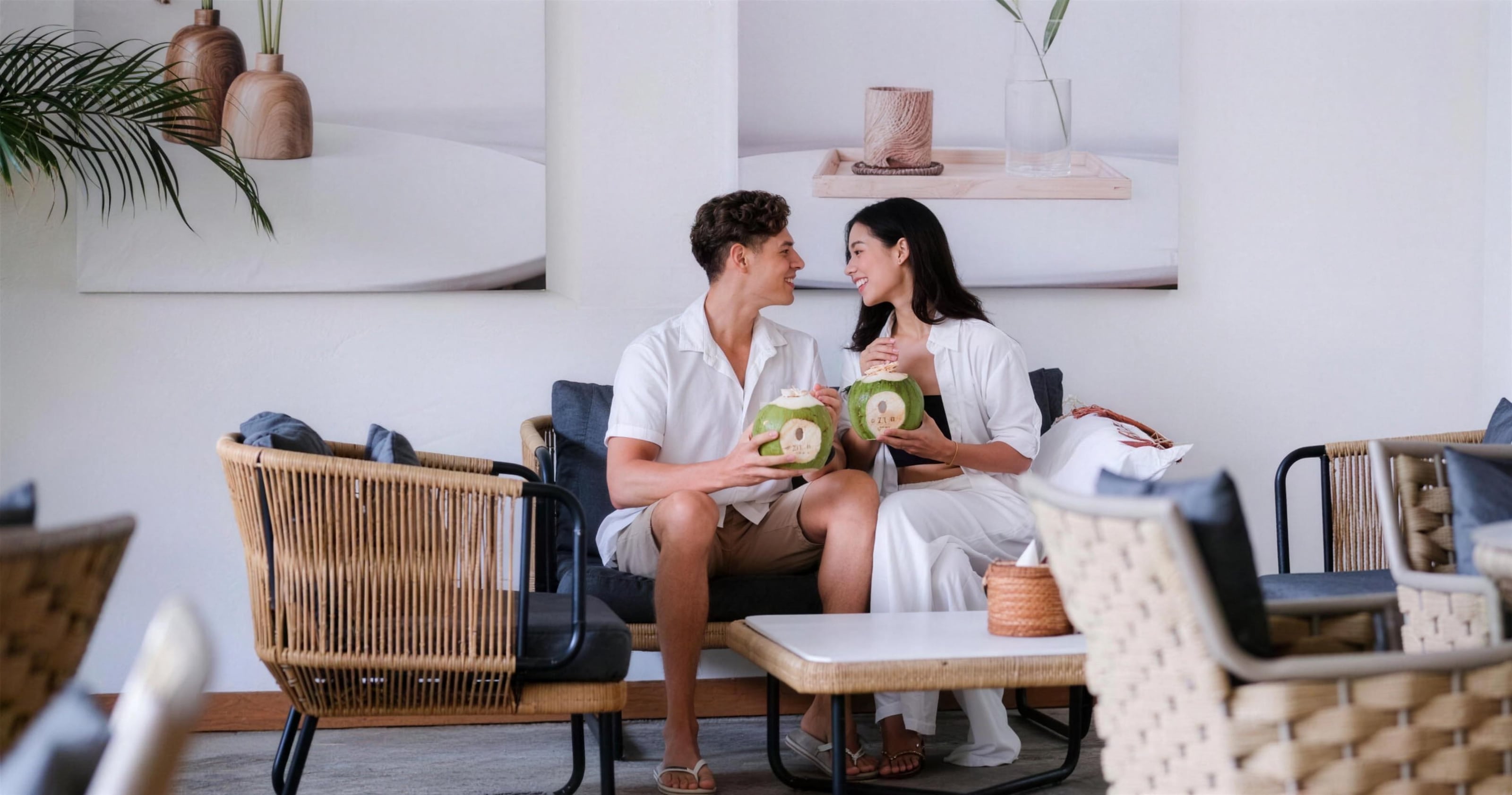 Two guests relaxing with fresh coconuts in the lounge
